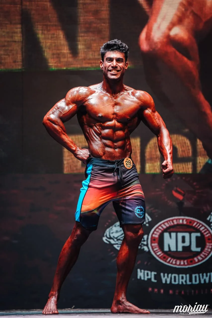 Zohaib Alam on stage at an NPC competition